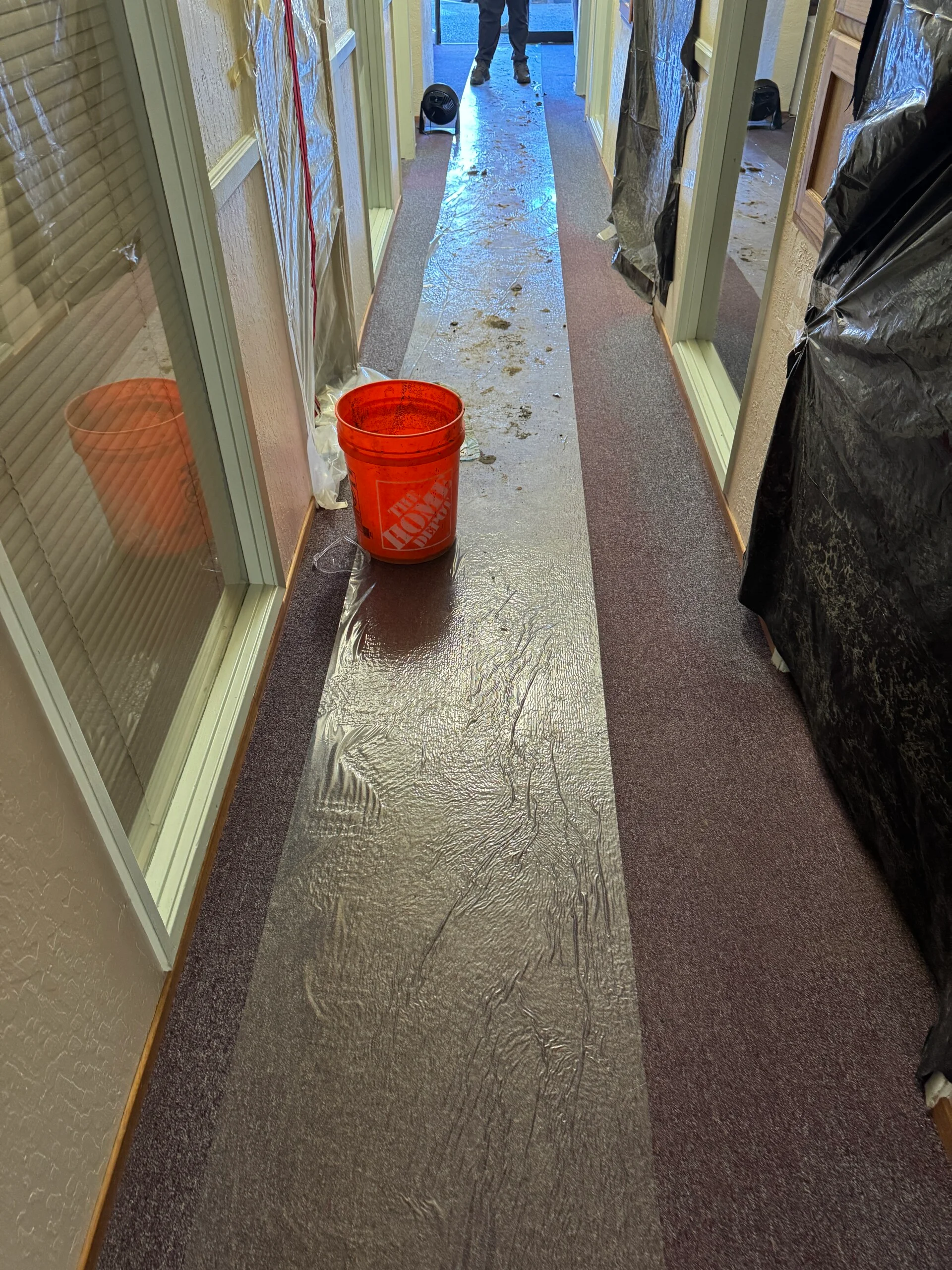 Emergency plumbing response setup with containment barriers